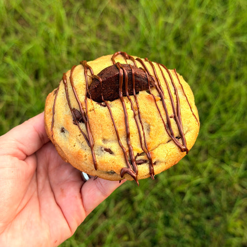 Brown sugar dough with chocolate chips, stuffed with a brownie, drizzled with milk chocolate 